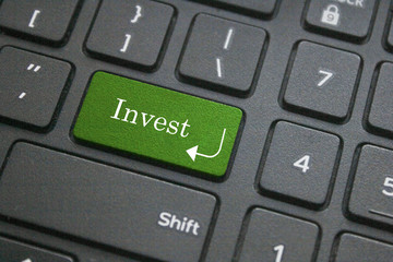 Close up of invest word on computer keyboard
