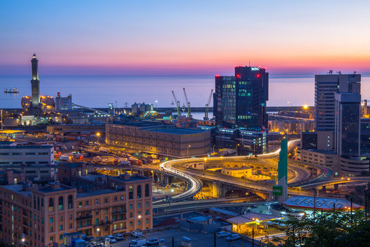 GENOA, ITALY OCTOBER 30, 2016 - Industrial area near the port with Lanterna and commercial skyscrapers at sunset