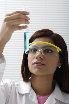 Scientist with vile of liquid