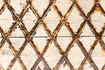 White wooden surface with rusty stripes in the rhombus form