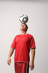 Soccer player with ball on head