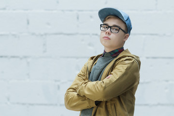 Portrait of teenage wearing cotton blue baseball cap and looking at camera