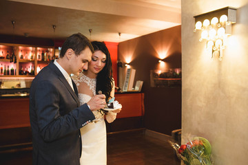bride and groom eating wedding  cake