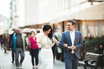 young bride and groom  walking in the beautiful town