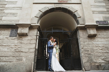 young  groom walking in the town with his woman