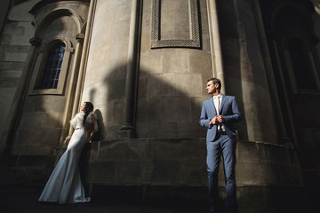 young  couple stand near the old  church