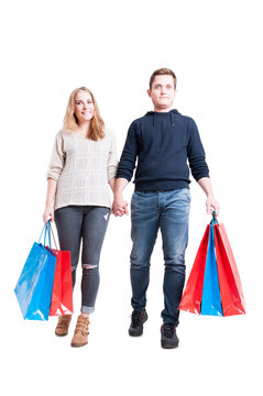 Full Body Of Couple Holding Bunch Of Shopping Bags