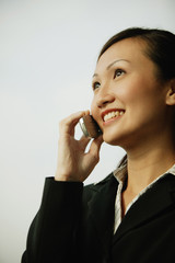 Young woman on mobile phone, smiling