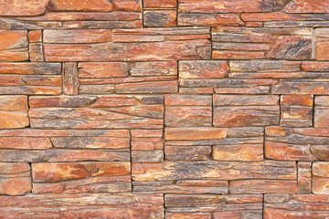Wall lined with red stone, background, texture