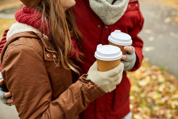 close up of happy couple with coffee in autumn