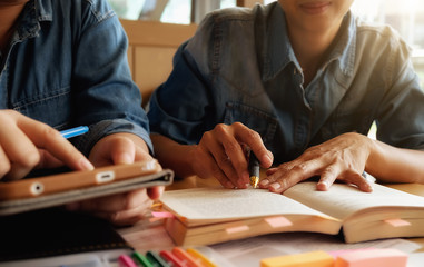 Education concept. Student studying and brainstorming campus concept. Close up of students discussing their subject on books or textbooks. Selective focus.