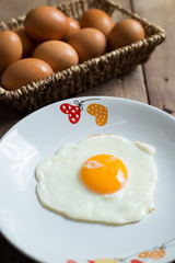 Fried egg on cooked rice and fresh eggs.