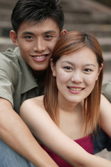 Couple smiling, looking at camera.