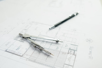 Desk of Engineering project in construction site or office with morning light.Construction concept.Engineering tools.Vintage tone retro filter effect,soft focus(selective focus)