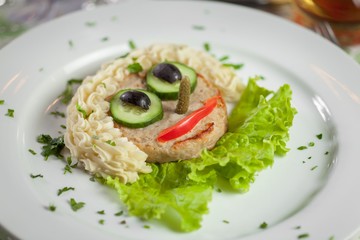 Food for kids. Cutlet with mashed potatoes and vegetables in the form of faces