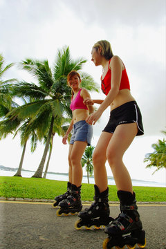 Two Women Inline Skating At Park