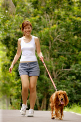Young woman walking with her dog
