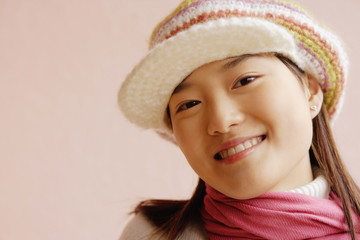 Young woman wearing cap, smiling
