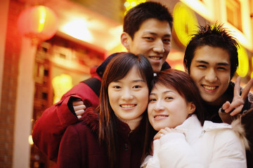 Young adults looking at camera, smiling