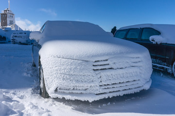 Snow covered frozen car.
