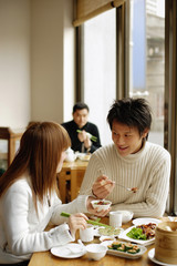 Young adults at a restaurant, eating