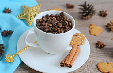 Cup of coffee beans with christmas decorations on wooden table
