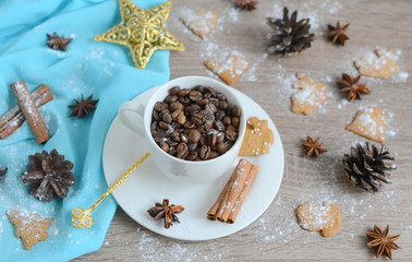 Cup of coffee beans with christmas decorations on wooden table

