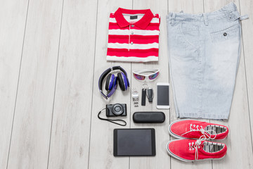 Set of mens fashion, accessories, colored sneakers and tech gadgets from above.