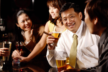 Couples at bar, drinking