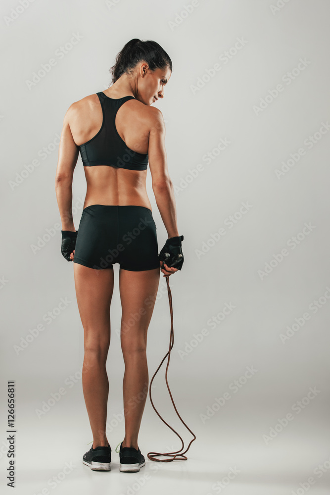 Poster Fit healthy young athlete with a skipping rope