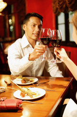 Couple toasting with wine at restaurant