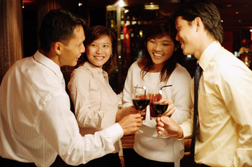 Young executives standing, toasting with wine