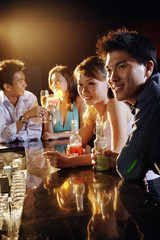 Young adults sitting at bar