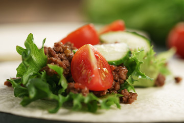open tortilla with beef, frillice and vegetables