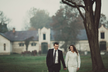 Happy wedding couple is walking down