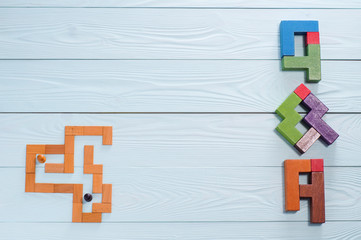 Concept search Answer: the man in the maze and  letters Q & A, made from wooden blocks, top view,...