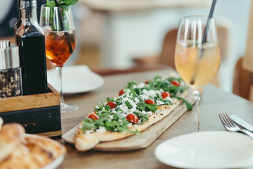 turkish pide with feta cheese, rucola and tomato in restaurant
