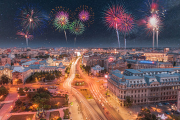 Aerial view of the capital city of Romania, Bucharest. Night sky with stars and fireworks....