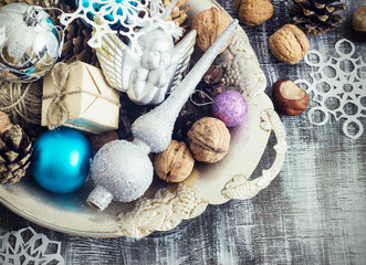 Fototapeta na wymiar Christmas Composition of balls, cones and snowflakes in a metal bowl. Vintage style. toning
