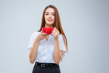 The young business woman on gray background