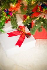 Fototapeta na wymiar Decorated Christmas tree and gift on toned background