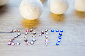 many small white balls toys symbol of the new year on a wooden , top view, there is a place for...