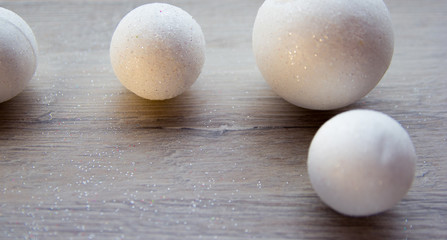 many small white balls toys new year symbol on wooden background , top view, there is a place for the text as a background and substrate