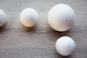 many small white balls toys new year symbol on wooden background , top view, there is a place for the text as a background and substrate