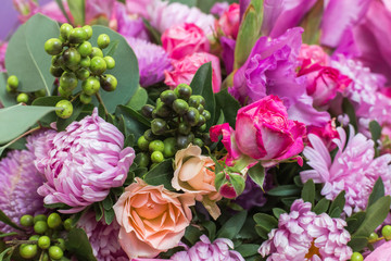 Close up of bouquet of many bright not fresh ugly flowers of different kinds.