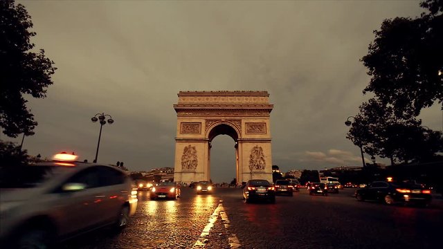 Triumphal arch. Paris. France. Static camera, real time. Place Charles de Gaulle. Famous touristic architecture landmark. Symbol of french glory. World historical heritage. Evening traffic. Toned