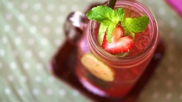 Fresh summer drink red strawberry, lemon and mint serve in mason jar