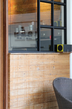 Concept and design front of coffee shop with speaker and black chair.