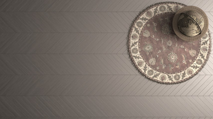 Old fashioned background with vintage globe, persian round carpet and wooden herringbone floor