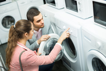 Couple choosing washing machine